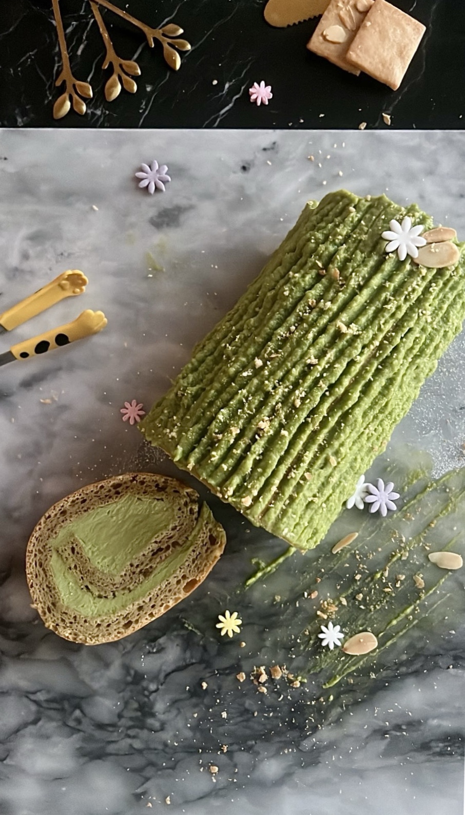 Matcha cake roll filled with matcha cream and decorated with matcha cream on top